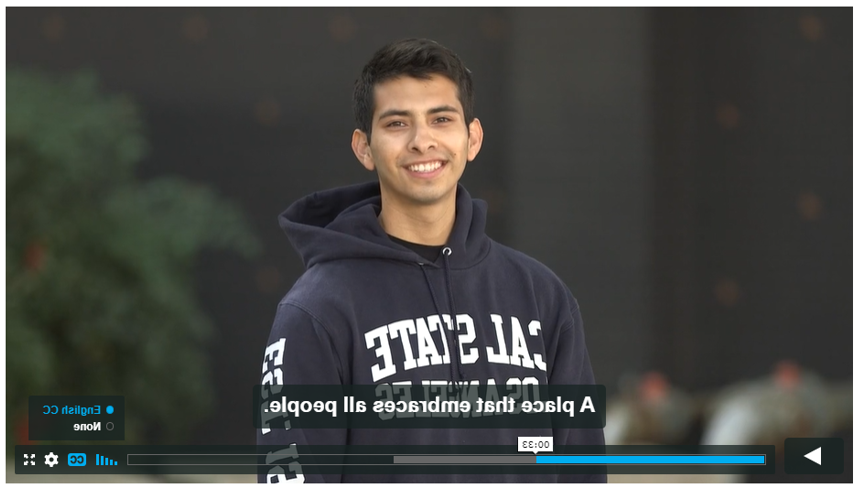 Screenshot of Campaign for Cal State LA video. Student with Cal State LA sweatshirt, English captions read "A place that embraces all people"